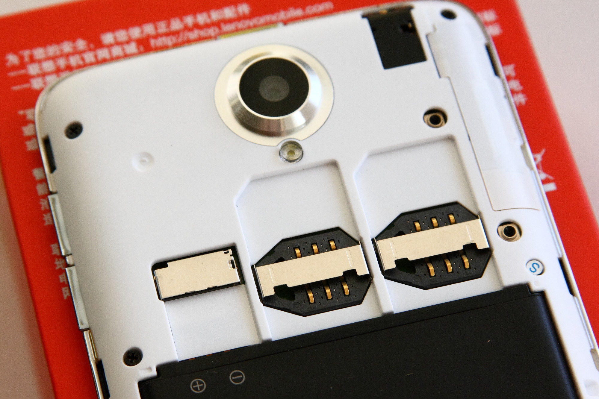 手機背蓋下的雙 SIM 卡槽與 MicroSD 卡槽特寫 — mineo 三家回線可選示意